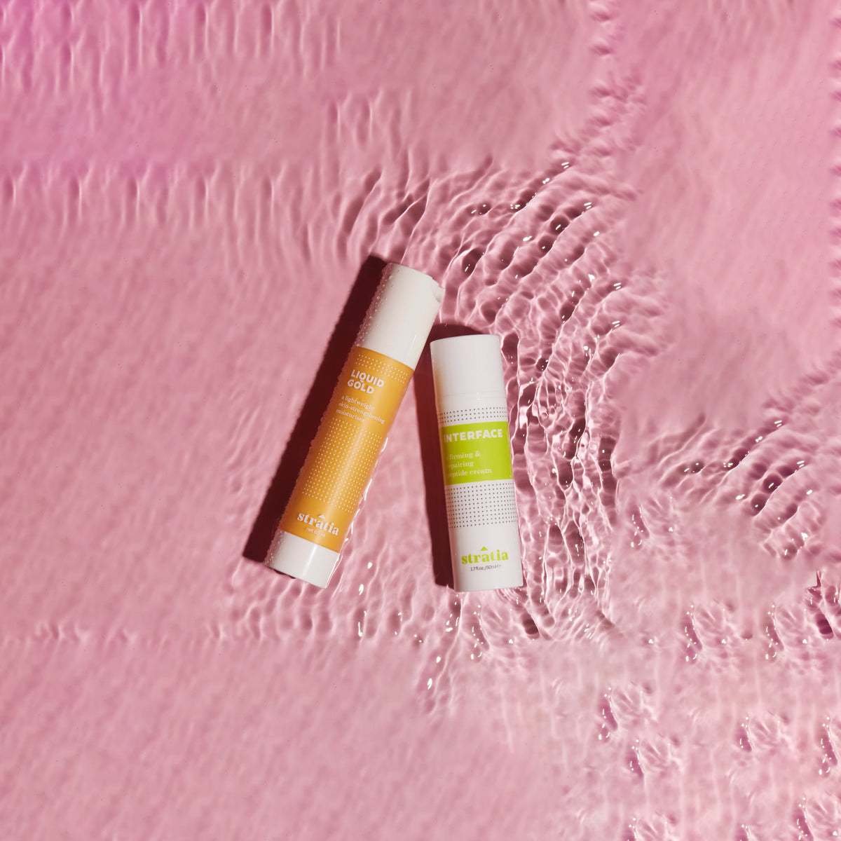 Stratia Liquid Gold and Interface on a pink background