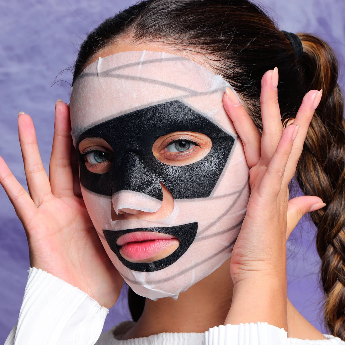 Skeleton-style animated face sheet mask covering forehead and cheeks