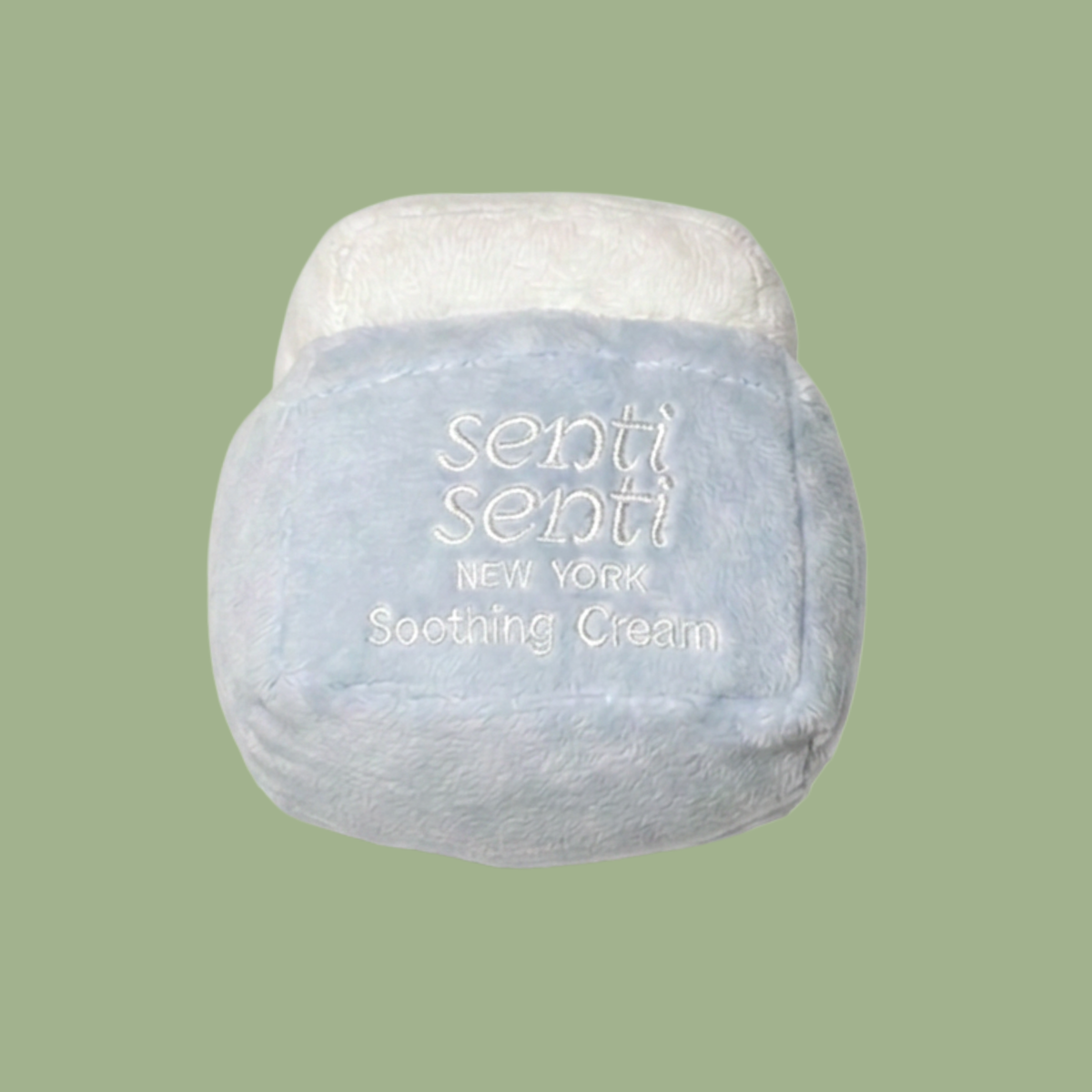 Cream and light-blue plush dog toy with centered 'senti senti NEW YORK Soothing Cream' text